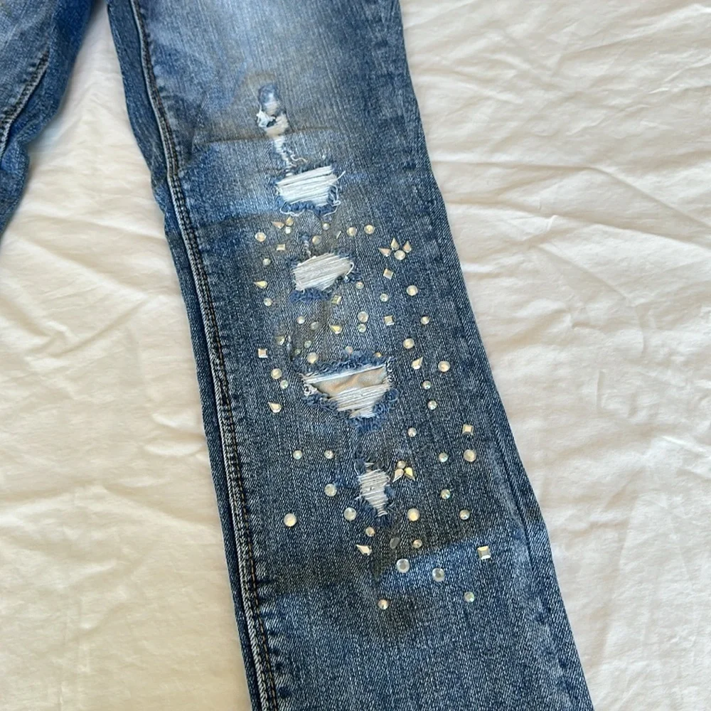 Black Daisy jeans with gem embellishments and rips w/ silver lining 26.5” inseam